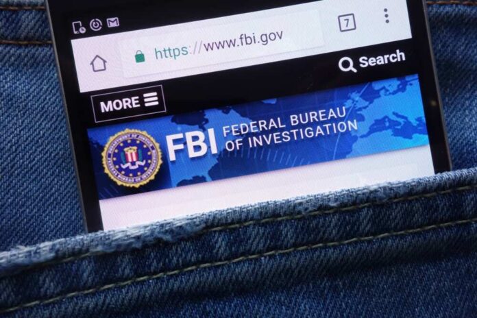 Mobile phone displaying the FBI website in a denim pocket
