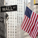 Spy Chief Shake-Up: Wall Street Lawyer? Street signs for Wall Street and Broad Street with American flags in the background