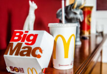 Golden Arches Has a New Plan A Big Mac box and a McDonald's drink on a wooden table