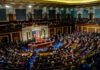Full chamber meeting with numerous attendees and speakers.