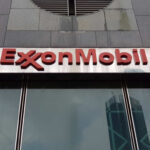 ExxonMobil logo displayed on a glass building
