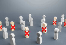 97,000 Job Cuts – Is THIS the REAL Reason? Wooden figures with red X marks, signifying eliminated individuals.