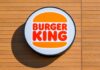Burger King logo displayed on a wooden wall