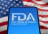 FDA Shocker: New Sunscreen Finally Approved FDA logo displayed on a smartphone with an American flag background