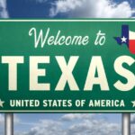 Welcome sign for Texas with the state flag