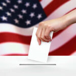Court Smackdown Spurs Conservative State Power Grab Hand dropping ballot into box, American flag background.