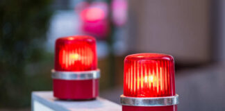 Two red warning beacons lit on a barrier