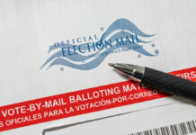 Blue Map Upended: Famous State Dumped Vote-by-mail envelope with pen on top.