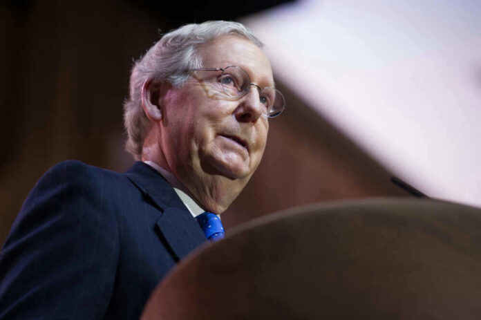 shutterstock_180961442 Mitch McConnell at a podium speaking.