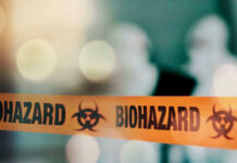 Salad Greens Blamed For Explosive Outbreak Biohazard tape with blurred figures in background.