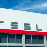 Tesla building with logo against blue sky