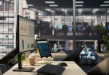 Huge Pivot, 9,000 Jobs Vanish Computer monitor with analytics dashboard in a modern open office