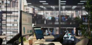 Computer monitor with analytics dashboard in a modern open office