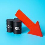 Oil Calm, War Smolders — What’s Off Here? Three black oil barrels with the word 'OIL' and a red downward arrow