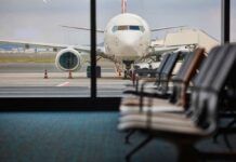 View of an airplane from an airport waiting area