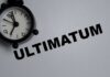 Trump Loads 1,000 Missiles Over Assassination Threats A black alarm clock next to the word 'ULTIMATUM' on a gray background