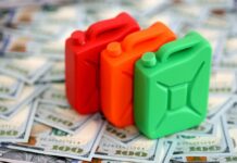 War Premium Slams Pumps — $4 Gas Returns Three colorful plastic containers on a background of hundred dollar bills