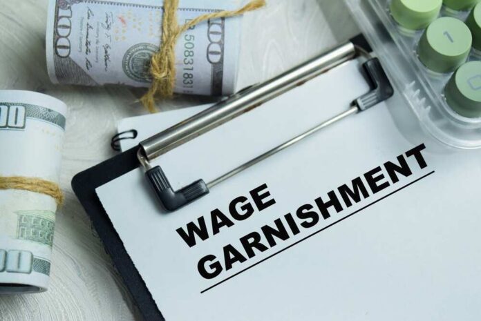 Concept,Of,Wage,Garnishment,Write,On,Clipboard,Isolated,On,Wooden