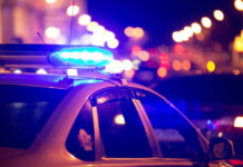 Mass Shooting Horror, No Arrests Police car with flashing blue lights at night.