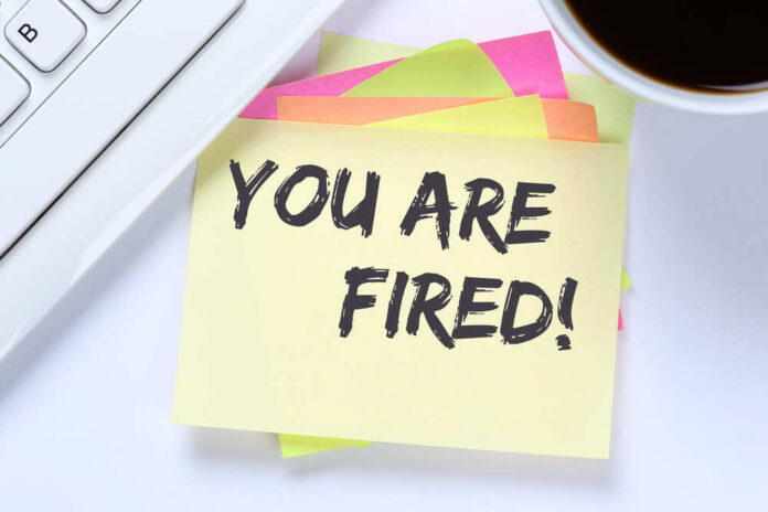 You,Are,Fired,Employee,Losing,Jobs,,Job,Working,Unemployed,Business A sticky note with the message 'YOU ARE FIRED!' placed on a desk next to a keyboard and a cup of coffee