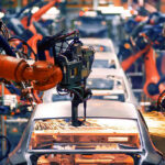 Texas Tax Breaks Lure Toyota Robotic arms welding car bodies in an automotive factory.