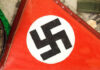 Close-up of a red flag featuring a black swastika symbol
