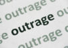 Rescuers Hit — Outrage Erupts Close-up of the word 'outrage' printed in bold on paper