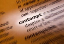 Blurred dictionary entry focusing on the word 'contempt'