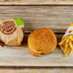 Burger King hamburger and fries on a wooden surface