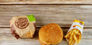 Burger King hamburger and fries on a wooden surface