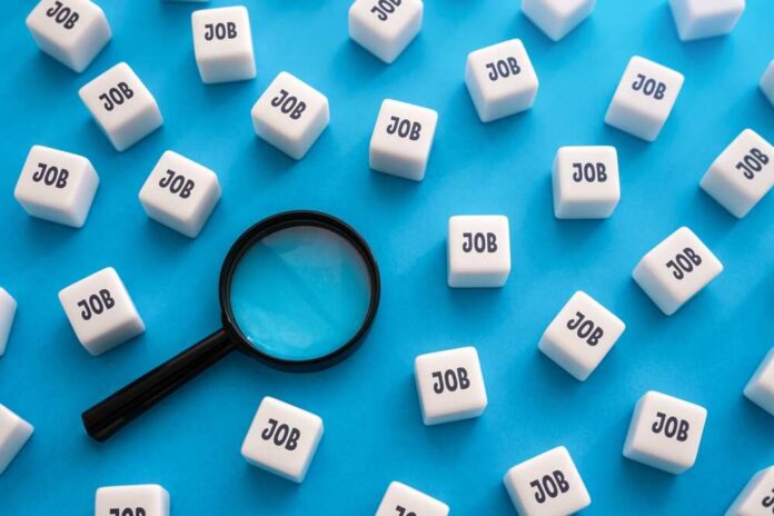 Search,For,Job,Openings,And,Vacancies.,Best,Offers,On,The Magnifying glass among cubes labeled job on blue background