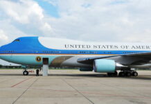 Airplane on runway with visible landing gear engines