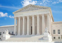 United States Supreme Court building with statues and columns.