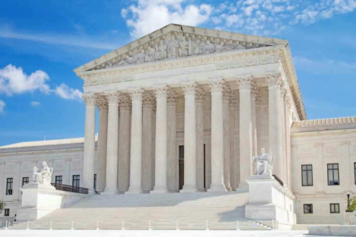 shutterstock_2312619675 United States Supreme Court building with statues and columns.