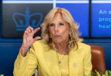 Jill Biden yellow speaking and gesturing with hand