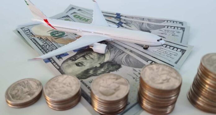 Passenger,Aircraft,And,Rising,Airfare.,Discount,And,Booking,Air,Ticket. An airplane taking off near an airport control tower