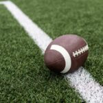 VIDEO: Tragedy After Touchdown As Player Dies Football player kneeling on the field with a helmet beside them