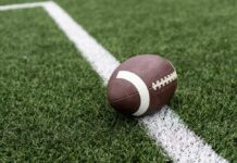 VIDEO: Tragedy After Touchdown As Player Dies Football player kneeling on the field with a helmet beside them