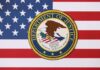 Department of Justice seal on American flag background