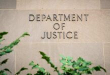 Department of Justice building wall with engraved lettering