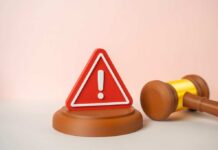 Abuse Of Power Or Hard Law-And-Order? A red warning sign next to a legal gavel on a light background