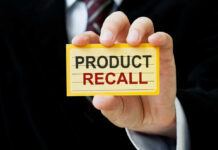 Baked Spaghetti Bombshell — 23,000 Pounds Gone Hand holding a product recall card