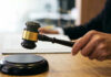 Fired For Bathroom Breaks? Huge Lawsuit Erupts Gavel in judges hand about to strike.