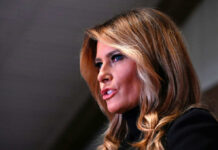 Melania’s Wall Street Power Play Melania Trump in a close-up side profile speaking