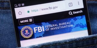 Mobile phone displaying the FBI website in a denim pocket