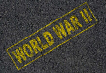 WWII Time Capsule Revealed The words 'WORLD WAR II' printed in yellow on a dark asphalt surface