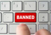 Red banned key on computer keyboard pressed