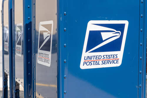 Row of blue United States Postal Service mailboxes