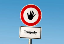Island Hop Turns Deadly Nightmare Road sign with hand stop symbol and a lower sign reading Tragedy