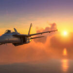 Fighter jet flying towards sunset over the ocean.